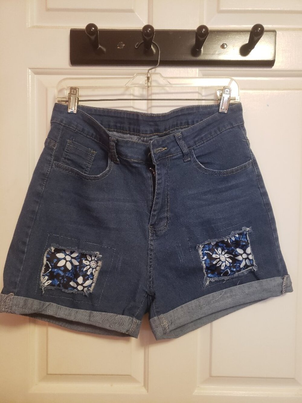 Blue jean shorts with patches blue with flowers.